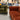 Luxurious Chesterfield fabric sofa set featuring a 3 seater and armchair in green and rust velvet upholstery