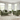 Green Penny 2 seater fabric sofa with matching armchair in bright living room with large windows and beige rug