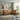 Winnington corner chaise sofa in warm tan leather styled in a modern living room with panelled walls and large garden windows