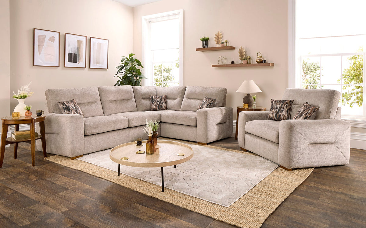 Rosie corner sofa and loveseat around a round coffee table on layered cream and jute rugs
