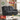 A dark gray upholstered reclining loveseat shown in a styled living room interior, with promotional sale text overlays including 'Free 7 Day Delivery', 'SAVE EXTRA 10% off', model name Florence, price details, and a 'SHOP NOW' callout.