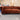 Rust velvet Chesterfield 3 seater sofa with button tufting and rolled arms in industrial showroom setting