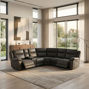 Dark gray fabric sectional sofa with two manual recliners and plush cushioned seats in bright modern living room