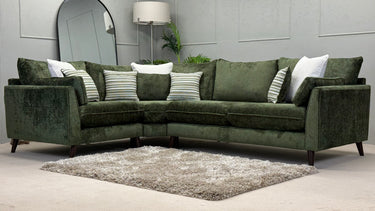 Green Penny 1 corner fabric sofa with striped and solid cushions on a beige carpet in a modern living room setting
