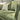 Close-up view of the Penny 3 Seater Fabric Sofa in green with striped pillows and soft textured cushions