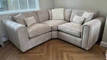 Beige Roxy Night 1.5 Corner 1.5 Modular Fabric Sofa with cushions in bright living room corner on wooden floor