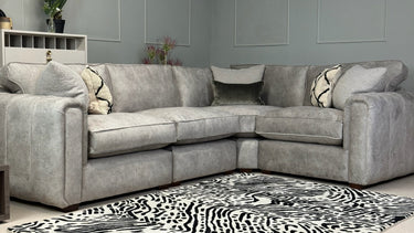 Roxy Night 3 corner 1.5 fabric sofa in grey with cushions, modern design, placed in a living room setting with patterned rug.
