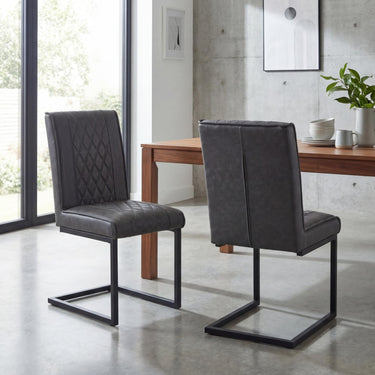 Wyatt Leather Effect Dining Chair - Grey – styled in a dining room